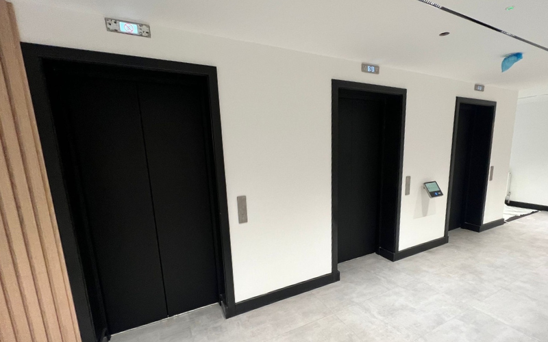 Architectural vinyl wrapping of lift doors and reveals in large office space